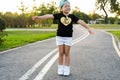 Fashion kid concept - portrait of stylish little cute girl child wearing a cap outdoors in the city. Royalty Free Stock Photo