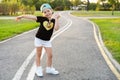 Fashion kid concept - portrait of stylish little cute girl child wearing a cap outdoors in the city. Royalty Free Stock Photo