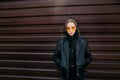 Fashion kid concept - stylish girl child wearing black casual clothes and sunglasses posing summer in the city Royalty Free Stock Photo