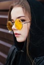 Fashion kid concept - stylish girl child wearing black casual clothes and sunglasses posing summer in the city Royalty Free Stock Photo