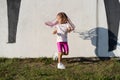 Fashion kid concept - stylish little girl child wearing bright clothes against the white wall. Royalty Free Stock Photo