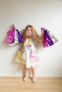 Fashion kids shopping. Beautiful smiling little girl
