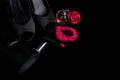 Fashion Lady Accessories Set. Black and pink. Minimal. Shoes, bracelet, perfume, lipstick and bag on black background. Flat lay. Royalty Free Stock Photo