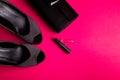 Fashion Lady Accessories Set. Black and pink. Minimal. Black Shoes, lipstick and bag on pink background. Flat lay. Royalty Free Stock Photo