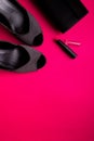 Fashion Lady Accessories Set. Black and pink. Minimal. Black Shoes, lipstick and bag on pink background. Flat lay. Royalty Free Stock Photo