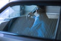 Fashion lady driving a car in a blue suit. Stylish girl sitting in the car and lying on the steering whee Royalty Free Stock Photo