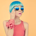 Fashion lady surprise in a blue wig and sunglasses