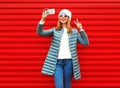 Fashion laughs woman takes a picture self portrait on a smartphone Royalty Free Stock Photo