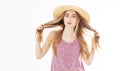 Fashion and lifestyle concept - beautiful woman in hat holding her hair curles enjoying summer outdoors isolated on white