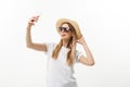 Fashion and Lifestyle Concept: pretty young woman wearing a hat, sunglasses takeing a photo of herself by mobile phone Royalty Free Stock Photo