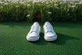 Fashion lifestyle Feet in white sneakers on lush green grass