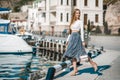 Fashion lifestyle portrait of young happy pretty woman laughing and having fun on the street at nice sunny summer day Royalty Free Stock Photo