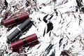 Lipstick tubes on shiny surface,empty space Royalty Free Stock Photo