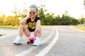 Fashion little girl child sitting on skateboard in city, wearing a sunglasses and t-shirt. Royalty Free Stock Photo