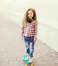 Fashion little girl child on skateboard in city Royalty Free Stock Photo