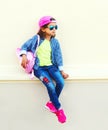 Fashion little girl child wearing a baseball cap and backpack Royalty Free Stock Photo