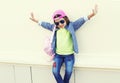 Fashion little girl child wearing a sunglasses and baseball cap in city over white Royalty Free Stock Photo