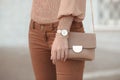 Fashion look autumn woman outfit. Stylish women`s beige handbag.