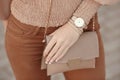 Fashion look autumn woman outfit. Stylish women`s beige handbag.