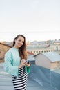 Fashion look, pretty cool young woman model with retro film camera. curly hair outdoors. Stylish girl photographer takes the old c Royalty Free Stock Photo