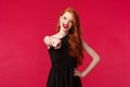 Fashion, luxury and beauty concept. Portrait of sassy and assertive redhead female in black dress and evening makeup