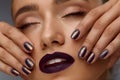 Fashion Makeup. Beautiful Woman With Dark Lips And Purple Nails Royalty Free Stock Photo