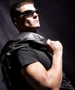 Fashion male whit sunglasses hold black jacket