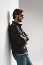 Fashion man, Handsome beauty male model portrait wear sunglasses and leather jacket, young guy over white background Royalty Free Stock Photo