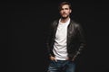 Fashion man, Handsome serious beauty male model portrait wear leather jacket, young guy over black background. Royalty Free Stock Photo