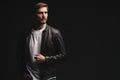 Fashion man, Handsome serious beauty male model portrait wear leather jacket, young guy over black background. Royalty Free Stock Photo