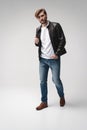 Fashion man, Handsome serious beauty male model portrait wear leather jacket, young guy over white background. Royalty Free Stock Photo