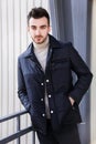 Man serious male model portrait blue jacket young guy gray background autumn winter black friday Royalty Free Stock Photo
