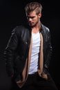 Fashion man in leather jacket is looking to his back Royalty Free Stock Photo