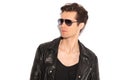 Fashion man in leather jacket and sunglasses looking to side Royalty Free Stock Photo