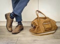 Fashion man legs in indigo navy blue pants, navy anchor socks, leather shoes and leather tote bag