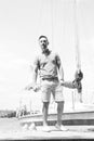 Fashion man portrait. river and yachts on background. sailor with yacht. Man portrait against yachts