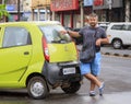 Fashion man posing near Tata Nano Royalty Free Stock Photo