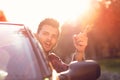 Fashion man sitting in luxury cabriolet car outdoors