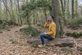 Fashion man talking on cell phone in beautiful forest.Male using smartphone, making a call outdoor technology concept lifestyle Royalty Free Stock Photo