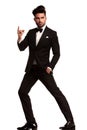 Fashion man in tuxedo snapping his finger Royalty Free Stock Photo