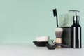 Fashion men toiletry accessories in black color in green mint menthe and white interior - razor, toothbrush, towel, soap.