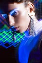 Fashion model beautiful girl in fashionable clothes in ultraviolet light, showing different poses. Beauty body and face. Royalty Free Stock Photo