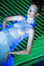 Fashion model beautiful girl in fashionable clothes in ultraviolet light, showing different poses. Beauty body and face. Royalty Free Stock Photo