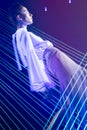 Fashion model beautiful girl in fashionable clothes in ultraviolet light, showing different poses. Beauty body and face. Royalty Free Stock Photo