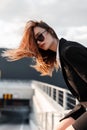 Fashion model beautiful young girl in dark vintage sunglasses in black stylish blazer in summer windy sunny day outdoors. Beauty Royalty Free Stock Photo