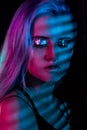 Fashion model blonde woman in colorful bright neon lights posing in studio. Royalty Free Stock Photo