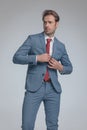 Fashion model closing his suit and looking away Royalty Free Stock Photo