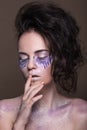 Fashion model with colorful make-up and blue glitter and sparkles on her face and body. Royalty Free Stock Photo