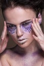 Fashion model with colorful make-up and blue glitter and sparkles on her face and body. Royalty Free Stock Photo