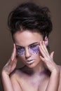 Fashion model with colorful make-up and blue glitter and sparkles on her face and body. Royalty Free Stock Photo